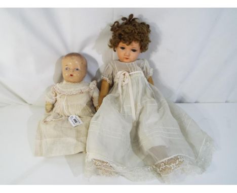 Vintage dolls - a pair of vintage dolls comprising a composite painted faced doll with leather soft body, marked to the head 