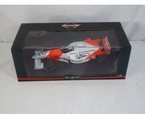 Minichamps - a 1:18 scale diecast F1 McLaren racing car bearing a signature (by repute that of David Coulthard), model is in 