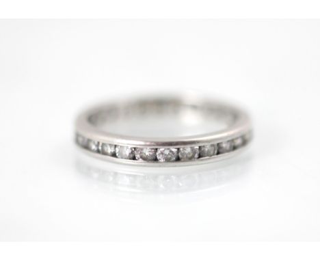 A platinum diamond full eternity ring, the twenty six round cut diamonds channel set in a plain polished platinum band, stamp