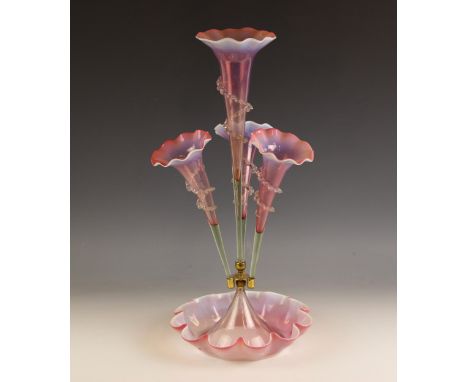 A pink vaseline glass epergne, 20th century, of typical form, with a central trumpet with three smaller trumpets below, each 