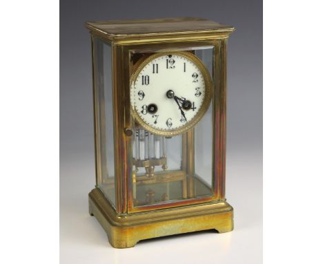 A French four glass mantel clock, early 20th century, the bevelled glass case enclosing a 9cm dial applied with Arabic numera