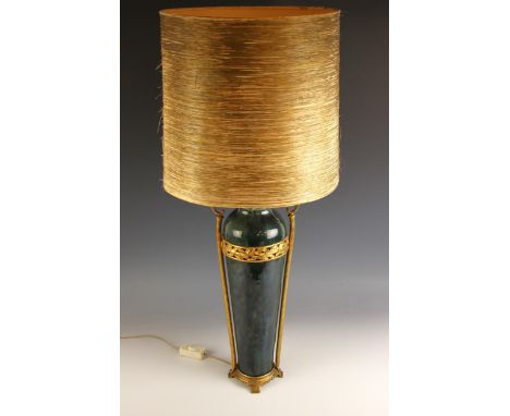 A modern neoclassical-style pottery and gilt metal table lamp, the mottled green glazed body set with a pierced ribboned laur