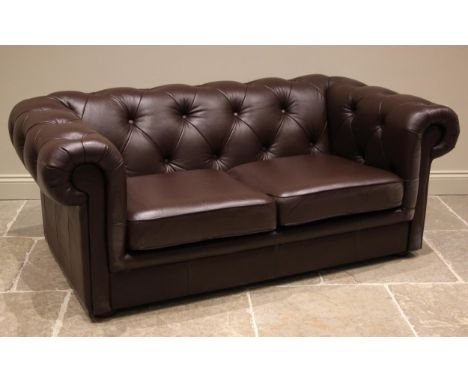 A nut brown leather Chesterfield sofa, late 20th/early 21st century, of typical deep seated form, the scrolled button back en