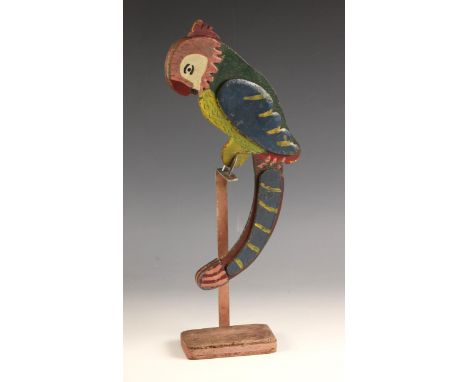 A folk art nodding parrot on stand, 20th century, the naively painted double sided body with weighted tail, balanced on a woo