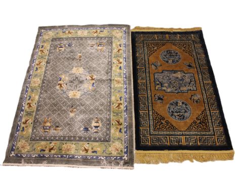 Two Chinese silk work rugs, the first with a central grey field and central foliate medallion, enclosed by a green ground rep