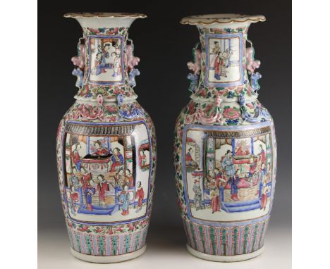 A pair of Chinese porcelain famille rose vases, Canton, 19th century, each of large baluster form and extensively decorated w