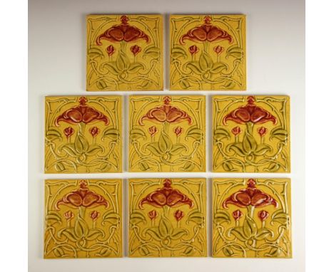 Eight Art Nouveau tiles, late 19th/early 20th century, each with a stylised floral and foliate design in a yellow, pink and g