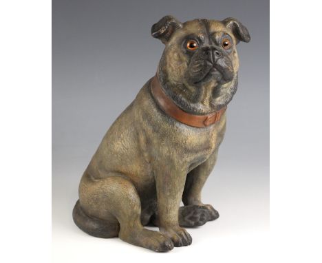 A cold painted pottery figure of a pug, late 19th/early 20th century, modelled seated, with orange collar and glass eyes, 29c
