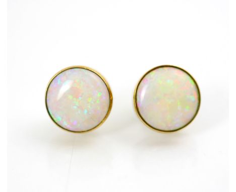 A pair of 9ct yellow gold mounted opal earrings, of circular cabochon form, within rubover yellow gold mount, with post and b