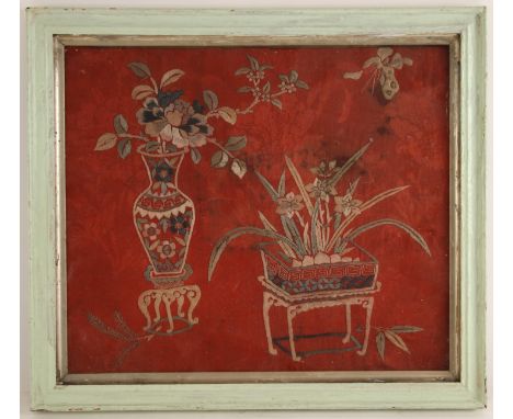 A Chinese silk embroidered red ground famille rose panel, 19th century, depicting a vase of flowers on stand and a flower tro