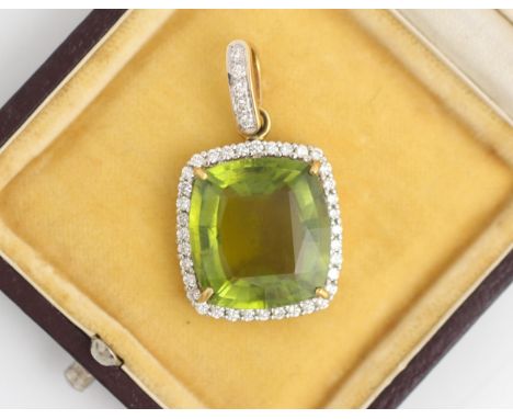 An untested green tourmaline and diamond pendant, the cushion cut green stone claw set within a surround of thirty six round 