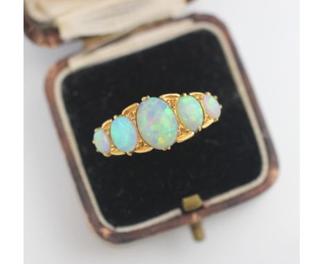 An early 20th century five stone opal ring, the central oval cut cabochon opal with two further graduated oval cabochons to e