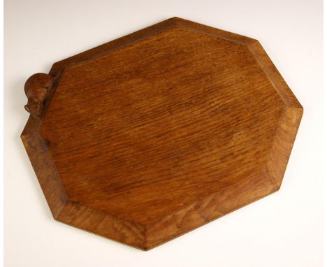 Workshop of Robert 'Mouseman' Thompson of Kilburn, a carved oak bread or cheese board, of canted rectangular form, with carve