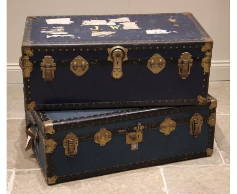 A blue canvas steamer/travel trunk, early 20th century, applied with metal corner brackets and banding, side leather loop han