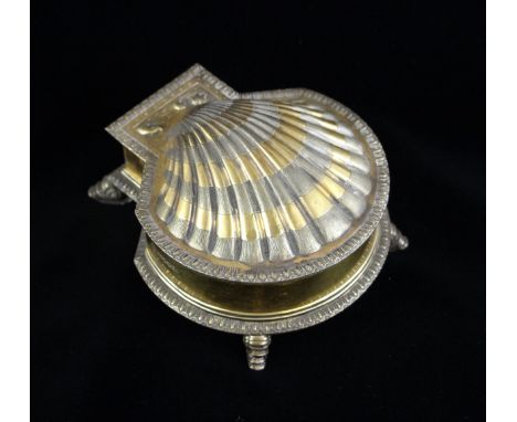 A Victorian silver gilt ink well, Robert Garrard, London 1881, designed as a shell, the hinged cover with stylised dolphin de