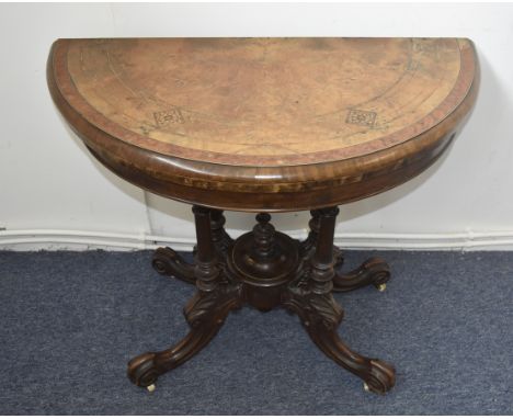 A Victorian walnut and inlaid card table, with swivel top, Tunbridge wear details, quadripartite base, scroll legs and cerami