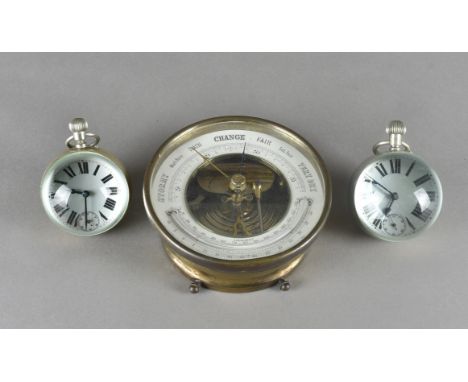 Two globe desk top fob watches, the glass front and reverse within a nickel plated collar with white enamel faces and Arabic 