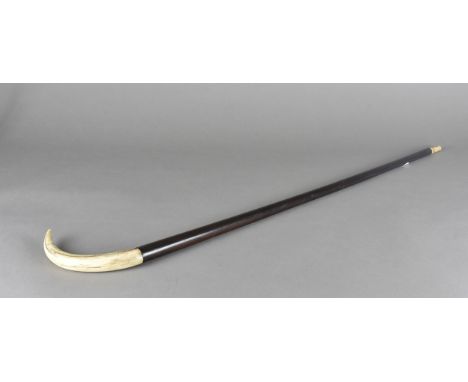 An early 20th Century ebony and boar tusk mounted walking stick, 91 cm long 