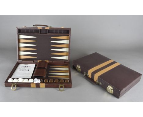 A leatherette backgammon set, together with another similar 