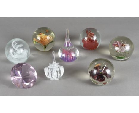 A Caithness glass 'Ringstand' paperweight, together with six other paperweights and another shaped like a brilliant cut diamo