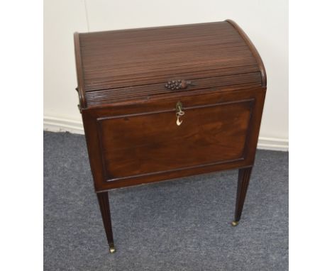 A Regency mahogany cellarette, tambour top with a grate finial, opening to reveal a fitted interior, on tapered reeded suppor