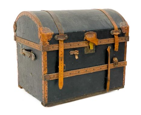 A leather and copper bound domed top trunk. Height 66cm width 76cm depth 52cm.