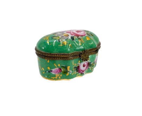 A French Limoges porcelain patch/pill box. 20th century, the green ground painted with floral bouquets, width 6.5cm.