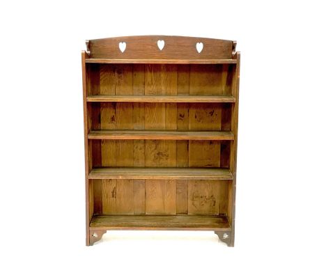 A Liberty &amp; Co Arts and Crafts oak open bookcase. With pierced heart motif on bracket feet, height 102.5cm width 92cm, de