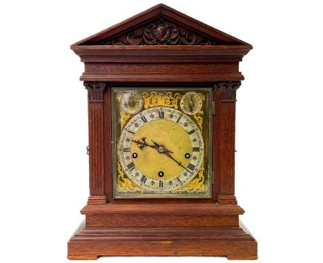 A late 19th century Winterhalder and Hofmeier oak cased mantle clock. With brass and silvered dial and architectural case, he