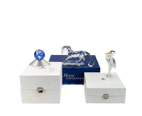 A collection of Swarovski crystal models.  To include a model of the globe with bird, a heron and a large horse, length - 20c