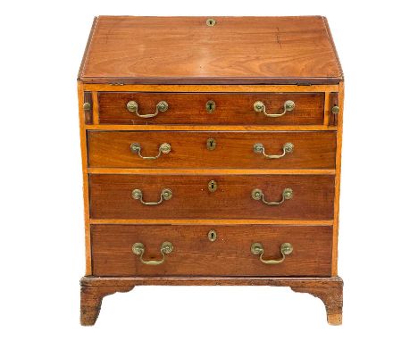 A 19th century mahogany bureau. The fall front encloses an arrangement of drawers and pigeonholes above four long drawers on 