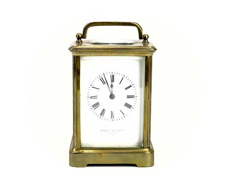 A French brass carriage clock. Circa 1900, the dial marked Howell James &amp; Co to the Queen Paris, height 13cm.