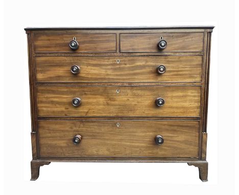 A George IV mahogany chest of two short and three long drawers. With mother of pearl inset turned wooden handles, cluster col