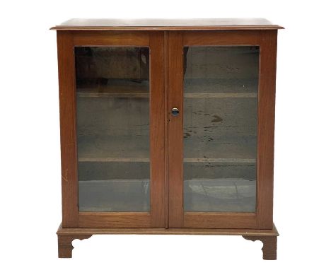 A late Victorian oak double front low bookcase. On shaped bracket feet, height 103.5cm width 97cm depth 38cm.