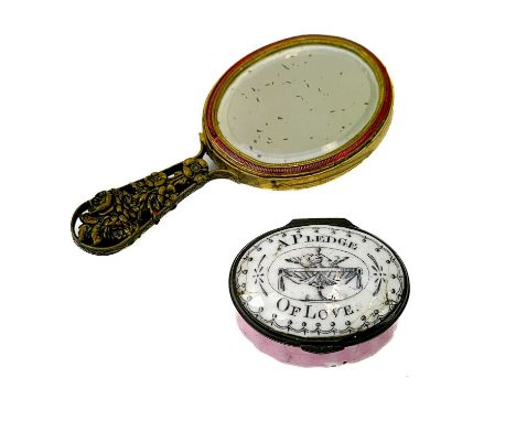 An enamel oval patch box, Battersea or South Staffordshire. The hinged cover inscribed A Pledge of Love, with pink enameled b