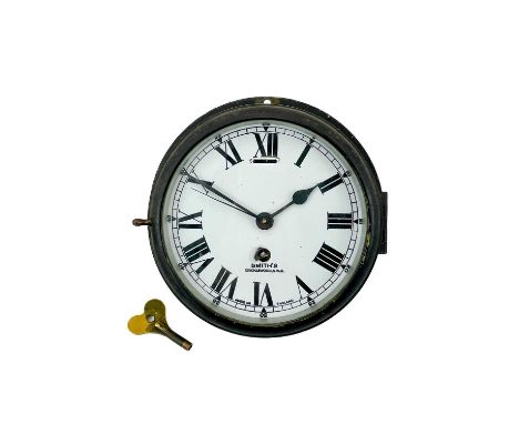 A Smith's bulkhead ship's timepiece. The white enamel dial inscribed Smith's Cricklewood, N.W.2, in a painted brass case, dia
