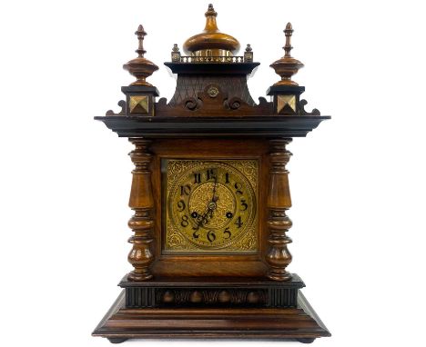 A German Black Forest style walnut mantel clock. Circa 1900, in an architectural style brass mounted case and with a brass em