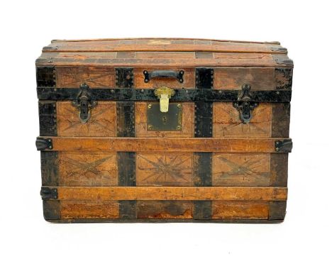 An oak and iron banded domed top trunk. Late Victorian, height 52cm width 73cm depth 47cm.