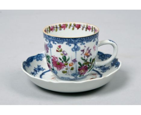 An 18c coffee cup and saucer decorated in underglaze blue and famille rose with a flower spray within shaped reserve together