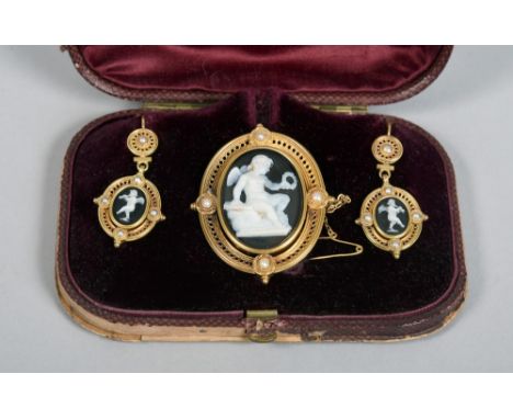 A Victorian three piece gold and cameo jewellery set,  the white on black cameos within pierced oval seed pearl mounted, comp