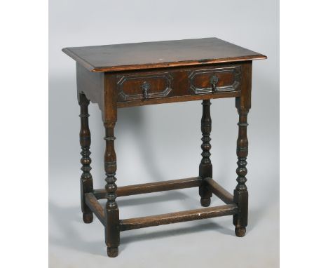 A late 17c style oak side table fitted one long drawer with geometric carving, supported on baluster bobbin turned legs with 
