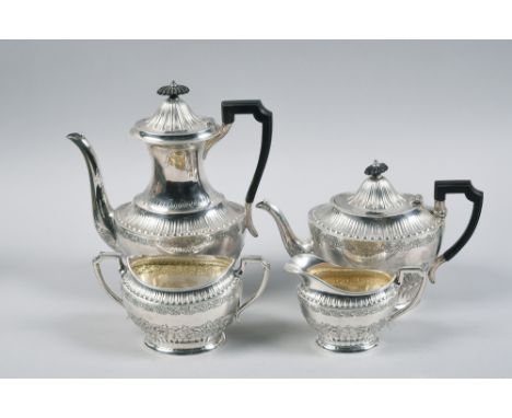 A late Georgian style four piece silver tea service comprising tea pot, coffee pot, sucrier and cream jug, chased with scroll