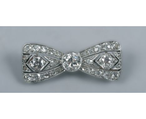 A diamond white gold set bow brooch, 1.5in w.