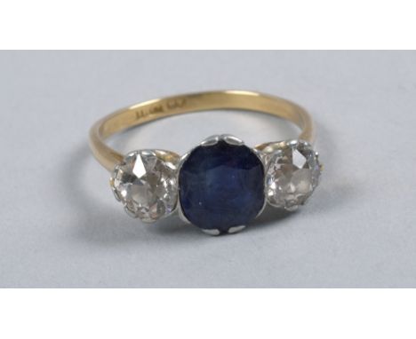 An 18ct gold ring set with central sapphire flanked by two diamonds, each approx 0.58 carats.
