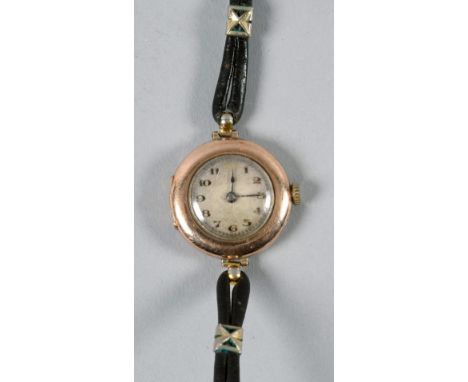 A ladies wrist watch by Rolex in 9ct gold case, hallmarked for 1915.  The faded dial has black arabic numerals with a red twe