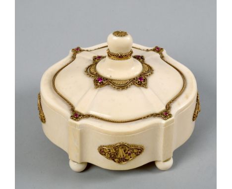 An early 20c European secessionist carved ivory ladies box, supported on four ball feet and decorated with gold and ruby moun