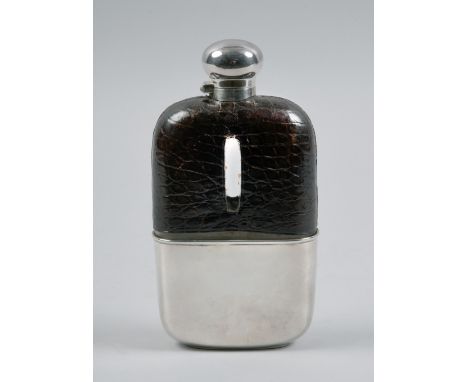 An Edwardian silver pocket flask with leather covered shoulders,having a pull off tot with a knob screw top, makers mark for 
