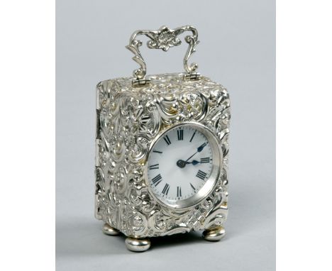 A small French carriage timepiece in English silver repousse case hallmarked for 1900 and stamped for Henry Matthews.  The en
