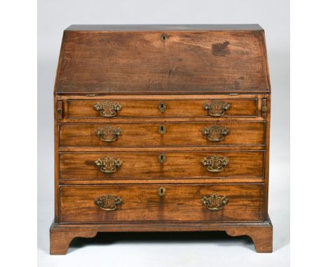 A George III mahogany bureau with fall front and fitted interior over four long graduated drawers and supported on bracket fe
