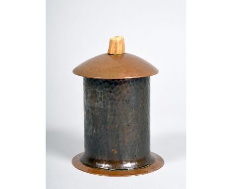 An Arts &amp; Craft copper pot and cover with beaten decoration throughout, having a lift off domed cover with horn finial, b